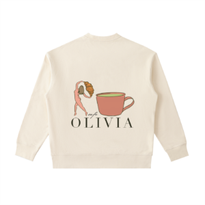 Beige sweatshirt displaying a Cafe Olivia logo: a stylized woman lifting a croissant toward a pink mug, with the words 'cafe OLIVIA' below.